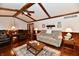 Comfortable living room featuring hardwood floors, wood beams, and a decorative rug at 1927 Pheasant Way, Greenwood, IN 46143