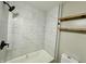 Renovated bathroom featuring a shower with white marble-look tile and wooden shelves at 1942 E Edgewood Ave, Indianapolis, IN 46227