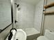Updated bathroom with shower and tub combo, black fixtures, and open wooden shelving at 1942 E Edgewood Ave, Indianapolis, IN 46227