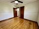 Inviting bedroom features warm hardwood floors and an open doorway to the rest of the house at 1942 E Edgewood Ave, Indianapolis, IN 46227