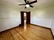 Charming bedroom features a ceiling fan, wainscoting, and beautiful hardwood floors at 1942 E Edgewood Ave, Indianapolis, IN 46227