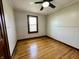 Bright bedroom featuring a ceiling fan, paneled walls, and natural light from the window at 1942 E Edgewood Ave, Indianapolis, IN 46227