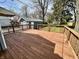 Spacious wooden deck perfect for outdoor entertaining and relaxing overlooking the lawn and detached garage at 1942 E Edgewood Ave, Indianapolis, IN 46227
