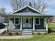 Charming single-story home with a covered front porch, beautiful landscaping, and great curb appeal at 1942 E Edgewood Ave, Indianapolis, IN 46227