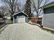 Detached one-car garage with a gravel driveway and fenced yard, offering secure parking at 1942 E Edgewood Ave, Indianapolis, IN 46227