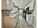 Modern kitchen with white cabinets, sleek countertops, stainless steel appliances, and updated fixtures at 1942 E Edgewood Ave, Indianapolis, IN 46227