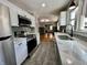 Updated kitchen with modern appliances, quartz countertops, and a seamless transition to the living spaces at 1942 E Edgewood Ave, Indianapolis, IN 46227