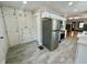Well-appointed kitchen with white cabinetry, stainless steel appliances, and easy access to the living room at 1942 E Edgewood Ave, Indianapolis, IN 46227
