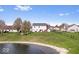 Spacious backyard with a scenic pond view, well-maintained lawn, and a charming fence at 19510 Pathway Point, Noblesville, IN 46062