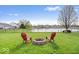 Lush backyard featuring a fire pit and chairs, perfect for enjoying evenings near the pond at 19510 Pathway Point, Noblesville, IN 46062