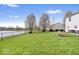 The backyard has seating, a pond view, and lush greenery, creating a perfect outdoor oasis at 19510 Pathway Point, Noblesville, IN 46062