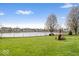 Enjoy the expansive backyard with fire pit, seating, and scenic pond views, great for outdoor living at 19510 Pathway Point, Noblesville, IN 46062
