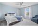 Bedroom featuring a blue accent wall, neutral carpeting, and large window at 19510 Pathway Point, Noblesville, IN 46062