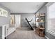 Bonus room features a treadmill, shelving, and an adjacent bathroom at 19510 Pathway Point, Noblesville, IN 46062