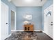 Inviting entryway features a wooden accent table, neutral paint, and durable flooring at 19510 Pathway Point, Noblesville, IN 46062
