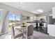 Bright kitchen features white cabinetry, stainless steel appliances, and sliding glass door access to backyard at 19510 Pathway Point, Noblesville, IN 46062
