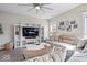Inviting living room with a media center, neutral sectional, and lots of natural light at 19510 Pathway Point, Noblesville, IN 46062