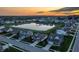 Aerial view showcasing homes around a pond with fountain and tree-lined streets at 20515 Quicksilver Rd, Noblesville, IN 46062