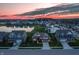 Aerial view of homes surrounding a pond with a fountain and a colorful sky at 20515 Quicksilver Rd, Noblesville, IN 46062