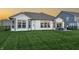 Spacious backyard with patio and lush green lawn at sunset at 20515 Quicksilver Rd, Noblesville, IN 46062