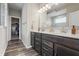 Bathroom with dual sinks, dark brown cabinets, white countertops, and access to the closet at 20515 Quicksilver Rd, Noblesville, IN 46062