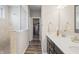 Bathroom with a glass door shower, dual sinks with white countertops, and access to the closet at 20515 Quicksilver Rd, Noblesville, IN 46062
