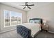 Inviting bedroom featuring a plush bed with stylish bedding, a ceiling fan, and a large window, offering comfort and relaxation at 20515 Quicksilver Rd, Noblesville, IN 46062