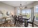 Bright dining room with a chandelier, dark wood table set, and sliding doors to a patio at 20515 Quicksilver Rd, Noblesville, IN 46062
