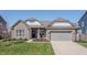 Charming home with brick and siding, a well-manicured lawn, a 2-car garage, and great curb appeal at 20515 Quicksilver Rd, Noblesville, IN 46062