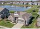 Beautiful home with water view, brick and siding, a well-manicured lawn, and a 2-car garage at 20515 Quicksilver Rd, Noblesville, IN 46062