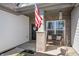 Welcoming front porch featuring an American flag, bench seating, and attractive brick accents at 20515 Quicksilver Rd, Noblesville, IN 46062