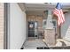 Inviting front porch with brick columns, a decorative flag, a welcome mat, and lush landscaping at 20515 Quicksilver Rd, Noblesville, IN 46062