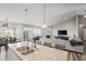 Bright and airy kitchen with a large island, stainless steel sink, and an open view to the living room and dining area at 20515 Quicksilver Rd, Noblesville, IN 46062