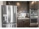 Modern kitchen with stainless steel refrigerator, espresso machine, and dark brown cabinets at 20515 Quicksilver Rd, Noblesville, IN 46062
