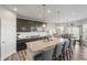 Modern kitchen with a large island, granite countertops, stainless steel appliances, and an open layout to the dining area at 20515 Quicksilver Rd, Noblesville, IN 46062