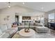 Spacious living room featuring vaulted ceilings, open layout to kitchen and dining area, and a comfortable sectional sofa at 20515 Quicksilver Rd, Noblesville, IN 46062