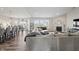 Open-concept living room with modern furnishings, fireplace, and seamless flow to the dining area at 20515 Quicksilver Rd, Noblesville, IN 46062