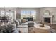 Inviting living room featuring a large sectional sofa, fireplace, and views of the outdoors at 20515 Quicksilver Rd, Noblesville, IN 46062