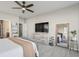 Bright main bedroom with a stylish bed, a ceiling fan, and a dresser with a large mirror at 20515 Quicksilver Rd, Noblesville, IN 46062