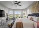 Spacious main bedroom with a stylish bed, a ceiling fan, and multiple windows with a water view at 20515 Quicksilver Rd, Noblesville, IN 46062