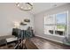 Bright home office featuring wood floors, window views, and custom bar for entertaining guests at 20515 Quicksilver Rd, Noblesville, IN 46062