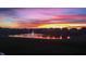Beautiful sunset view of pond and fountain, reflecting vibrant colors on the water's surface at 20515 Quicksilver Rd, Noblesville, IN 46062