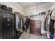Spacious walk-in closet with ample storage solutions, including shelves, hanging rods, and a safe, offering organization and security at 20515 Quicksilver Rd, Noblesville, IN 46062