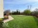 An expansive backyard with well-manicured lawn, basketball court, and nice landscaping at 2093 Autumn Faith Way, Avon, IN 46123