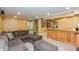 Cozy finished basement with sectional sofa, wet bar, and neutral color scheme for relaxation and entertainment at 2093 Autumn Faith Way, Avon, IN 46123