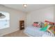 Bright bedroom features natural light from the window and a comfortable bed with colorful pillows at 2093 Autumn Faith Way, Avon, IN 46123