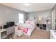 Bedroom with neutral colors features a desk for studying or working and a large bright window at 2093 Autumn Faith Way, Avon, IN 46123