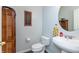 Half bath featuring a pedestal sink, sunflower decor and cabinet for convenient storage at 2093 Autumn Faith Way, Avon, IN 46123