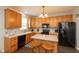 Well-equipped kitchen featuring wood cabinetry, modern appliances, and an island with seating at 2093 Autumn Faith Way, Avon, IN 46123