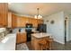 Cozy kitchen with island seating, wood cabinets, and black appliances provides a warm, inviting space at 2093 Autumn Faith Way, Avon, IN 46123